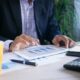 A business professional in the process of creating stacked charts on a tablet device.